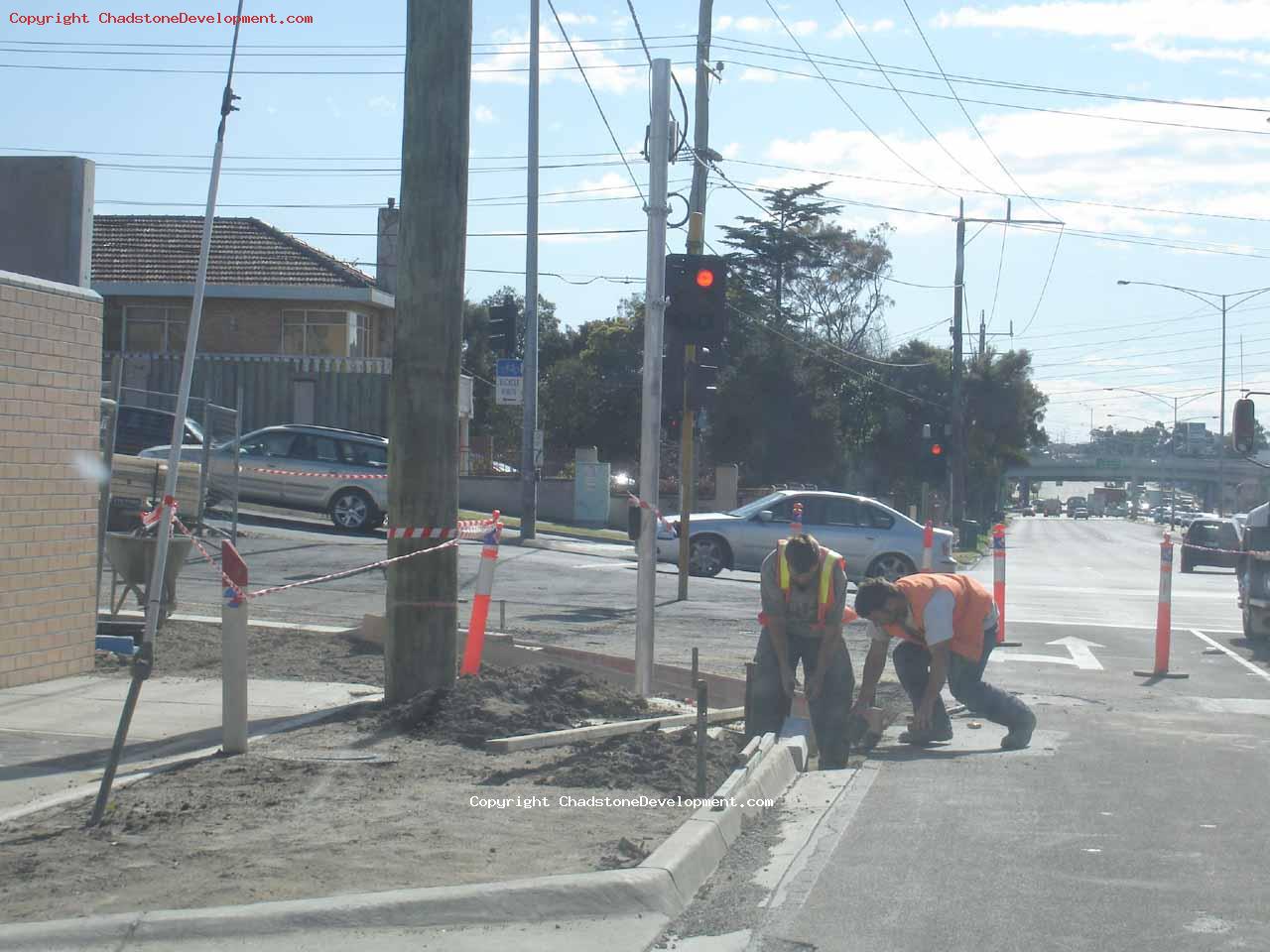 Workers install the new curb - Chadstone Development Discussions