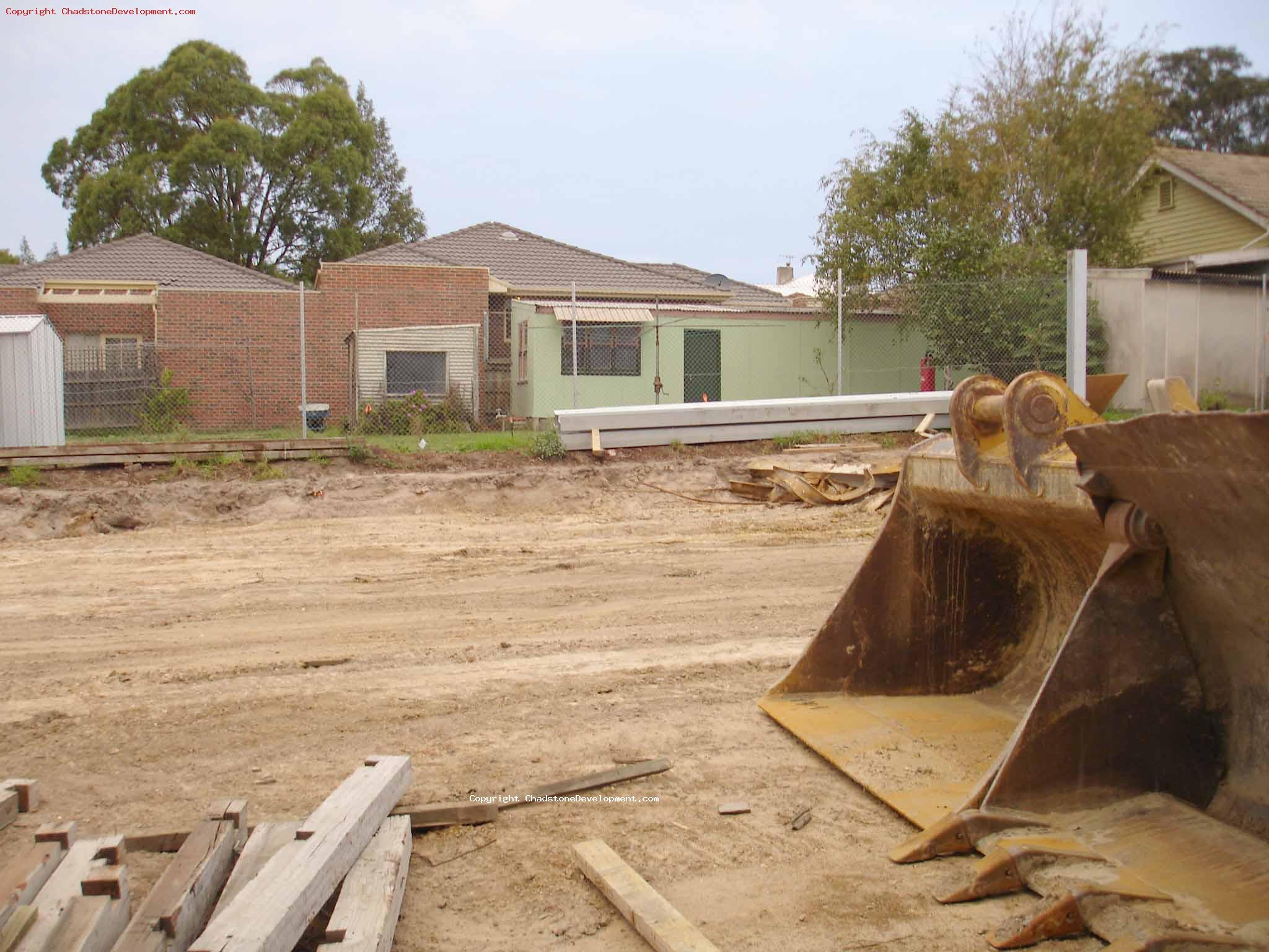 A peek through the remaining wood fence near warrigal rd - Chadstone Development Discussions