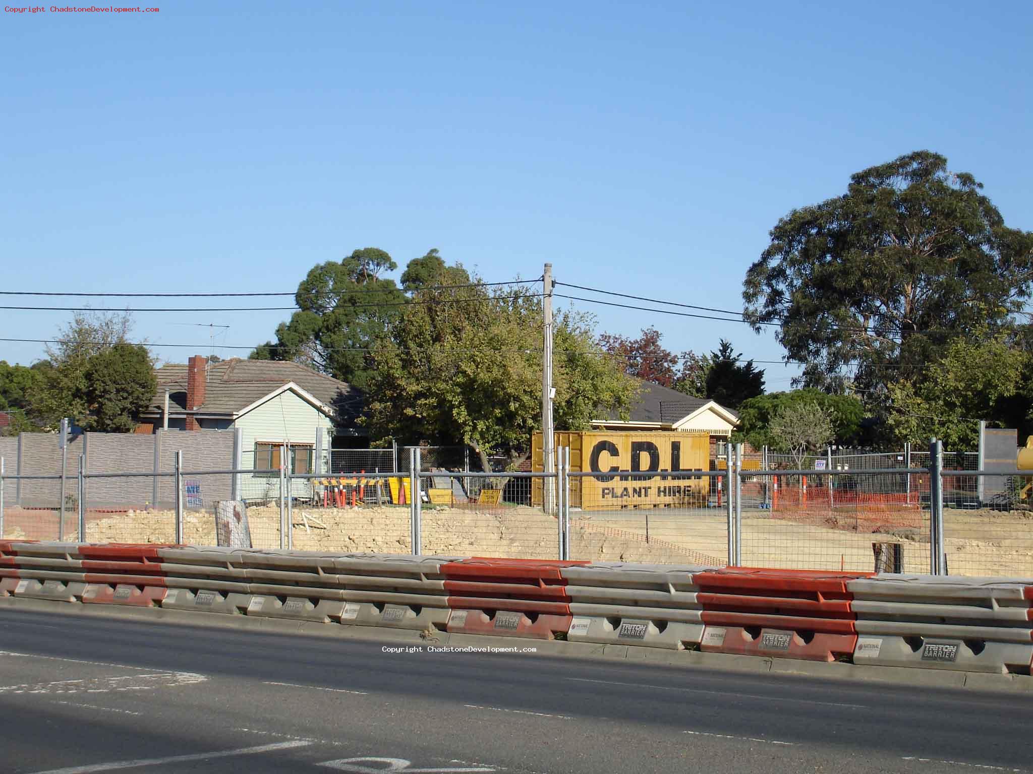 Trench behind the road, CDL shipping container - Chadstone Development Discussions